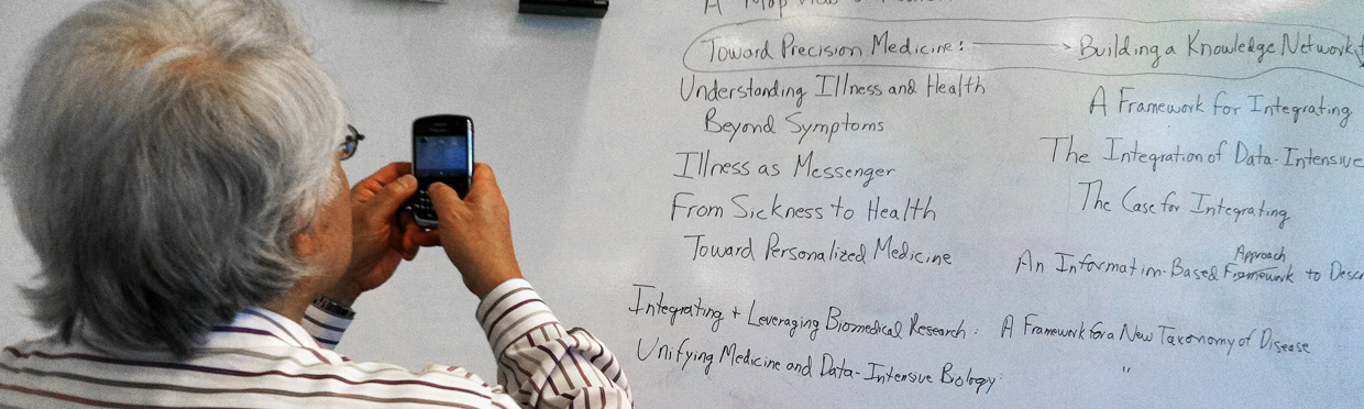 Keith Yamamoto takes picture of white board with "Precision Medicine" selected among other terms